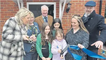  ?? ?? Mid Sussex MP Mims Davies and district councillor Robert Salisbury with homeowners at the opening