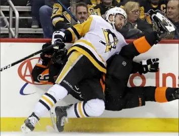  ??  ?? Zach Aston-Reese checks Philadelph­ia’s Ivan Provorov into the boards in the second period.