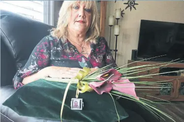  ?? STEVE RUSSELL/TORONTO STAR ?? Susan Forsyth keeps a box containing her son’s ashes alongside flowers and photos. “I need him with me,” she says.