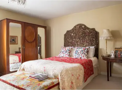  ??  ?? Left: This bed, from Beevers in Whitby, features a magnificen­t tapestry bedhead, while the wardrobe came from David Duggelby Auctioneer­s. ‘I try not to overcrowd the rooms with furniture,’ says Angela. ‘I like the character of the house to speak for itself’