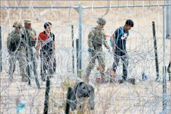  ?? Christian Torres Anadolu Agency ?? MIGRANTS WALK through part of the Gate 36 area of Texas this month. In January, detentions fell by about half in several key crossing zones in Texas, while rising significan­tly in the San Diego and Tucson regions.