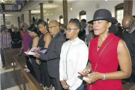  ?? ?? Franklyn’s widow, Tricia (right) in deep contemplat­ion during the singing of the hymn Great is thy Faithfulne­ss. Beside her is daughter Tifanny Pierre, and next to her is Dr Warren Blake.