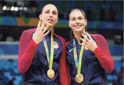  ?? Tom Pennington / Getty Images ?? UConn alums Diana Taurasi and Sue Bird celebrate after winning their fourth career gold medal at the 2016 Olympics in Brazil.