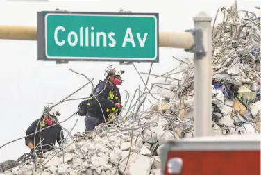  ?? Al Diaz / Associated Press ?? Search teams climb through debris of the 12story condo that collapsed in Surfside, Fla. The switch from rescue to recovery mode means the effort to find survivors is all but over. The death toll now stands at 54.