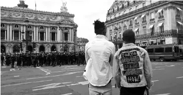  ??  ?? Police officers stand guard on the Opera square, near the Olympia, in Paris after the concert of Congolese artist Heritier Watanabe was cancelled due to clashes near the concert hall by protesters opposed to Democratic Republic of Congo’s president...