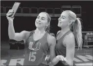  ?? Al Diaz
/ Miami Herald ?? Miami Hurricanes women’s basketball players Haley Cavinder (14), Hanna Cavinder (15) have more than $1 million in endorsemen­ts and have been at the forefront of college sports Name, Image, Likeness movement