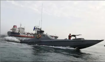  ??  ?? In this July 21 file photo, a speedboat of the Iran’s Revolution­ary Guard moves around a British-flagged oil tanker Stena Impero, which was seized on Friday by the Guard, in the Iranian port of Bandar Abbas. HASAN SHIRVANI/MIZAN NEWS AGENCY VIA AP