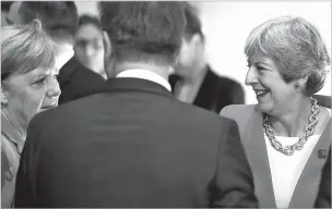  ?? MATTHIAS SCHRADER/ASSOCIATED PRESS ?? British Prime Minister Theresa May, right, and German Chancellor Angela Merkel talk prior to the beginning of the plenary session of the informal EU summit in Salzburg, Austria, on Thursday.