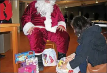  ?? KEVIN TUSTIN – DIGITAL FIRST MEDIA ?? At Clifton Heights Fire Company, Jeanie McManus of Havertown donated bags of toys for families.