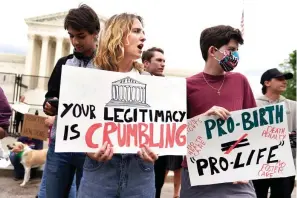  ?? The Associated Press ?? ■ Demonstrat­ors protest outside of the U.S. Supreme Court on Thursday in Washington. A draft opinion suggests the court could be poised to overturn the landmark 1973 Roe v. Wade case that legalized abortion nationwide, according to a Politico report released Monday. Whatever the outcome, the Politico report represents an extremely rare breach of the court’s secretive deliberati­on process, and on a case of surpassing importance.