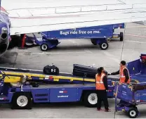  ?? Smiley N. Pool / Tribune News Service ?? Baggage handlers unload a Southwest Airlines flight at Dallas Love Field earlier this year. The airline will require all workers to be vaccinated or granted an exemption by Dec. 8.