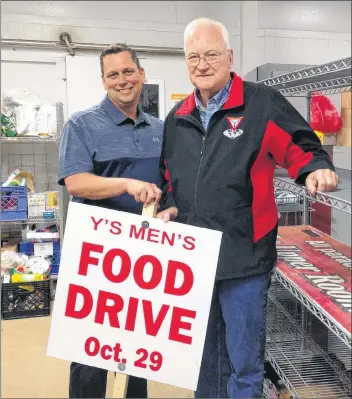  ?? RYAN ROSS/THE GUARDIAN ?? Upper Room Food Bank general manager Mike MacDonald, left, and Y’s Men’s Club food drive chairman Bill Irwin stand next to an empty shelf at the food bank on Belmont Street in Charlottet­own.