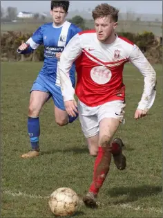  ??  ?? John Peare of Moyne Rangers is chased by Kevin Coleman of Tombrack.