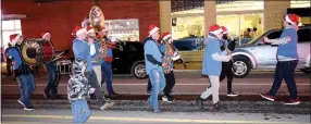  ?? Westside Eagle Observer/MIKE ECKELS ?? The Decatur High School marching band leads Santa Claus through the downtown area during the Decatur Christmas Parade Dec. 7 in Decatur.