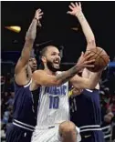  ??  ?? Magic guard Evan Fournier drives to the basket during the team’s overtime loss to the Nuggets on Wednesday.