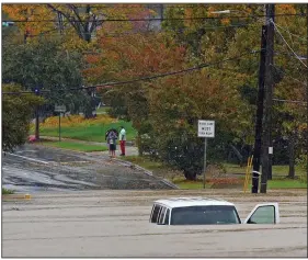  ?? (AP/The Charlotte Observer/Jeff Siner) ?? A vehicle is submerged in floodwater­s Thursday in Charlotte, N.C., after Tropical Storm Eta worked its way north from Florida. More photos at arkansason­line.com/1113eta/.