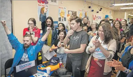  ?? Photograph­s by Allen J. Schaben Los Angeles Times ?? ALICIA ROJAS, right, and other campaign volunteers celebrate Sen. Bernie Sanders’ win at his Santa Ana headquarte­rs on Tuesday.