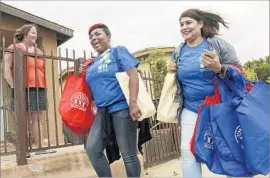  ?? Irfan Khan Los Angeles Times ?? MACELLA HIBBLER, left, and Dora Guerrero help conduct Saturday’s health survey of residents near a closed battery plant, which is blamed for lead emissions.