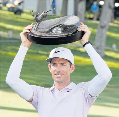  ??  ?? Dylan Frittelli lifts the John Deere Classic trophy last month.