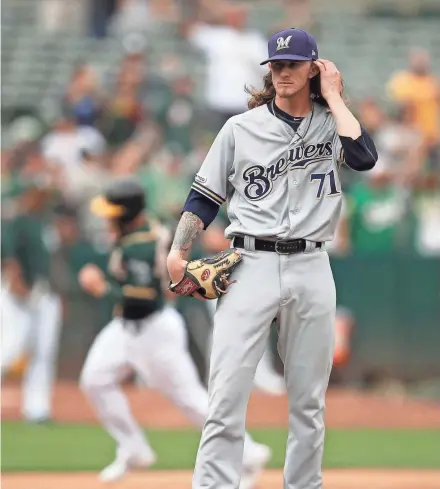  ?? AP ?? Josh Hader waits for the bases to clear after giving up a crushing two-run homer to Matt Chapman in the eighth.