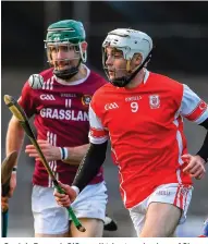  ??  ?? Cuala’s Darragh O’Connell tries to solo clear of Shane Stapleton and, below, Jake Malone of Cuala battles for possession with Dicksboro’s Thomas Kenny (left)