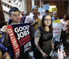  ?? HANS PENNINK, FILE — ASSOCIATED PRESS ?? In this June 1, 2016 photo, Bhairavi Desai, executive director of the New York Taxi Workers Alliance, center, speaks to reporters against allowing Uber and other app-based drivers to expand service to upstate New York, at the state Capitol on in...