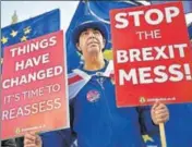  ?? AFP/FILE ?? An anti-Brexit protester holds placards as he demonstrat­es outside the British Parliament in London.