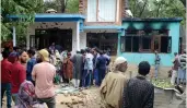  ?? — H. U. NAQASH ?? People inspect the damaged house where four militants and one policeman were killed during an encounter in Anantnag district.