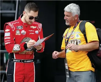  ?? PHOTOS BY GETTY IMAGES ?? LOCAL FAVORITE: Kaz Grala signs an autograph yesterday at New Hampshire Motor Speedway, where the Westboro native will drive in today’s NASCAR Xfinity Series race.