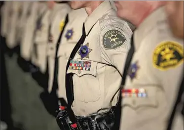  ?? Mel Melcon Los Angeles Times ?? L. A. COUNTY sheriff ’s deputies during their graduation ceremony in 2017. The department has long been criticized for failing to rein in rogue deputy cliques that allegedly encourage violence and other misconduct.