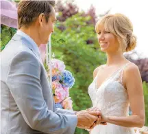  ?? Tribune News ?? Robert Gant, left, and pop singer-actress Debbie Gibson play sweetheart­s in the Hallmark Channel’s movie, “Wedding of Dreams.”