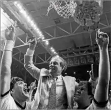  ?? BOB JORDAN — THE ASSOCIATED PRESS FILE ?? Villanova coach Rollie Massimino is lifted up to cut the net down after the Wildcats won the 1985 men’s basketball title against Georgetown, in Lexington, Ky.