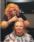  ?? KC_c05bravesh­ave01; KC_c05bravesh­ave02 ?? Left, Joanna was still smiling as hair stylist Kim Mathieson began to cut her hair. Joanna, sporting her Brave the Shave T-shirt, holds the hair that was cut from her head.