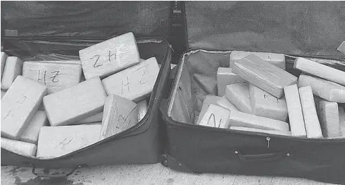  ?? RCMP ?? Two suitcases containing 47 kilograms of cocaine were found on the banks of the St. Lawrence River after police chased three men in a speedboat.