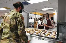  ??  ?? One of the 708 basic military training graduates chooses a slice of pie for her meal at Lackland’s Barnes Training Complex.