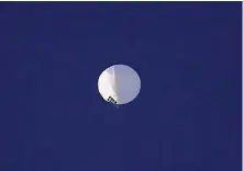  ?? Larry Mayer/Associated Press ?? A white balloon with solar panels floats over Billings, Mont., this week. The U.S. has been tracking a Chinese balloon officials described as an “intelligen­ce-gathering” airship.