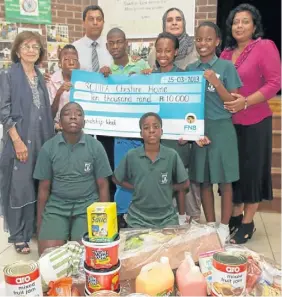  ??  ?? GIFT OF LOVE: Professor Fatima Mayet, Khethelo Doncabe, acting principal Raj Moodley, Thabani Malevu, Ayesha Essack, Adelaide Nkomo, Lethokuhle Ndaba and Sugen Reddy. Kneeling are Kelly Kasongo and David Misigaro