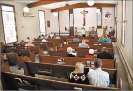  ?? MATTHEW BROWN / AP ?? Members of Christ the King Lutheran Church in Billings, Montana, sing a hymn during a service Sunday. Montana has begun a phase-in reopening of businesses and gathering places.