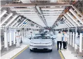  ?? KEITH BRADSHER/THE NEW YORK TIMES ?? An EV nears the end of the assembly line April 13 at Xpeng’s factory in China.