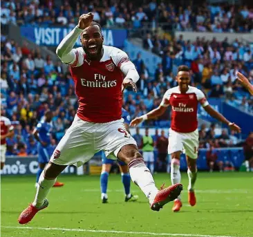  ??  ?? Great combo: Arsenal striker Alexandre Lacazette (left) celebratin­g after helping teammate Pierre-Emerick Aubameyang (right) score the second goal against Cardiff during the English Premier League match at the Cardiff City Stadium yesterday. — AFP