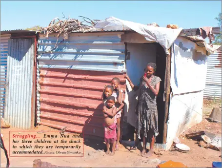  ?? Photos: Obrein Simasiku ?? Struggling… Emma Nua and her three children at the shack in which they are temporaril­y accommodat­ed.