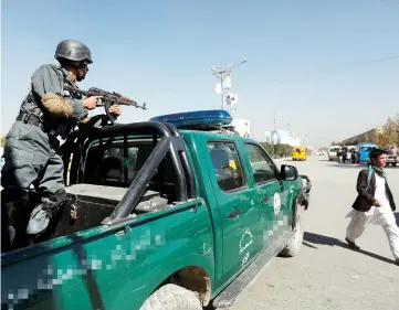  ??  ?? An Afghan policeman stands guard at a checkpoint ahead of parliament­ary elections in Kabul. — Reuters photo