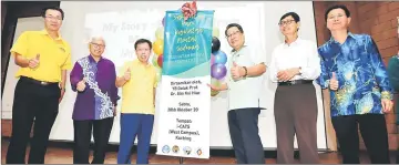  ??  ?? Dr Sim (third left), Wee (third right) and others pose for the camera after the launch of World Mental Health Day 2017 at i-CATS in Kuching.