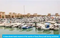  ??  ?? A view shows boats moored at the marina of Souq Sharq mall during lockdown.