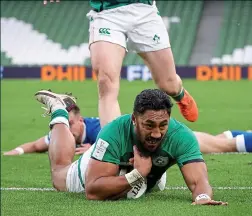  ??  ?? RAMPANT: Captain Johnny Sexton (main) crashes over the Italian try line following a sweeping Ireland move; Bundee Aki (above) later follows suit while CJ Stander (below) takes the fight to the Azzurri
