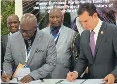  ?? ?? Minister of Energy and Power Developmen­t Edgar Moyo (middle) and Ambassador of Zimbabwe to the Lovemore Mazemo (left) look on as Eng Abel
UAE ZETDC MD Gurupira and Kerry Adler, President & of SkyPower, sign the PPAs
CEO