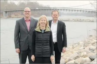  ?? Leah Hennel, Calgary Herald ?? Barbara Wilks of W architectu­re and Landscape, Calgary Municipal Land Corp. CEO Michael Brown, left, and Mark Johnson, a principal in the landscape architect firm Civitas, near St. Patrick’s Island.