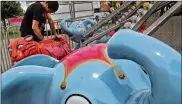  ?? BILL LACKEY / STAFF ?? A worker from Durant Enterprise­s gets a kiddie ride ready Tuesday for the start of the Clark County Fair on Friday. Increased fees for inspection­s was part of the recently passed state budget bill.