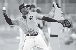  ?? AL DIAZ adiaz@miamiheral­d.com ?? Shown here during spring training, Marlins outfielder Lewis Brinson has been an unexplaine­d no-show since practices have resumed at Marlins Park this week.