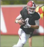  ?? NWA Democrat-Gazette/Andy Shupe ?? IN CONTENTION: Arkansas quarterbac­k Ty Storey carries the ball Thursday during the Razorbacks’ practice at the university’s practice facility in Fayettevil­le.